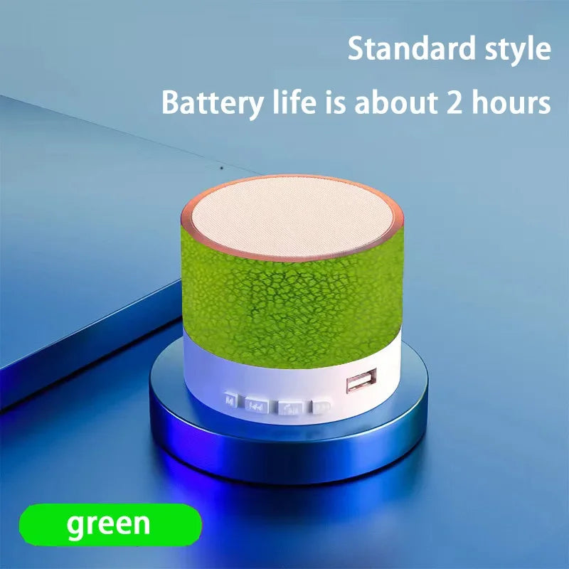Portable Bluetooth speaker with green textured body and beige top panel