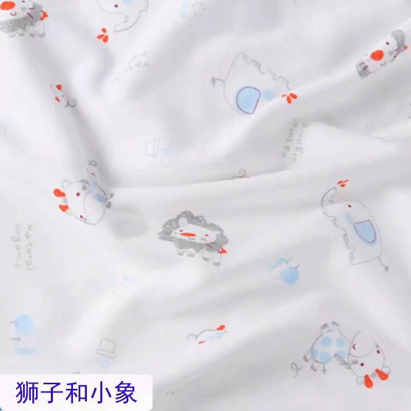 White organic jersey knit fabric featuring a cute, colorful print of lions and elephants for baby clothing.