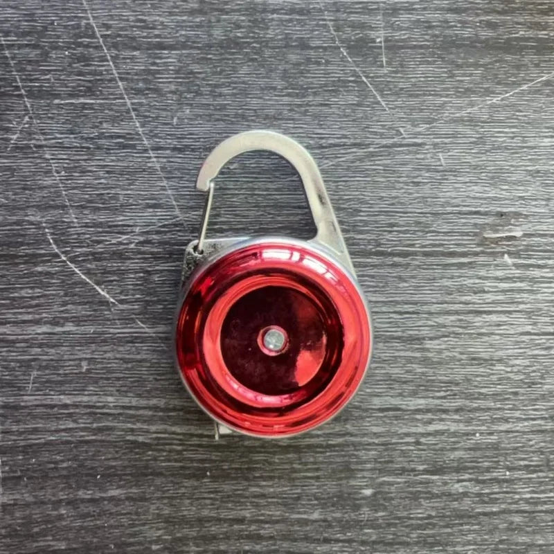Red round bubble vial level tool with arched handle and metallic base