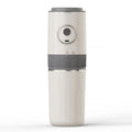Portable off-white electric coffee grinder with grey accents, power button, and USB-C charging port.