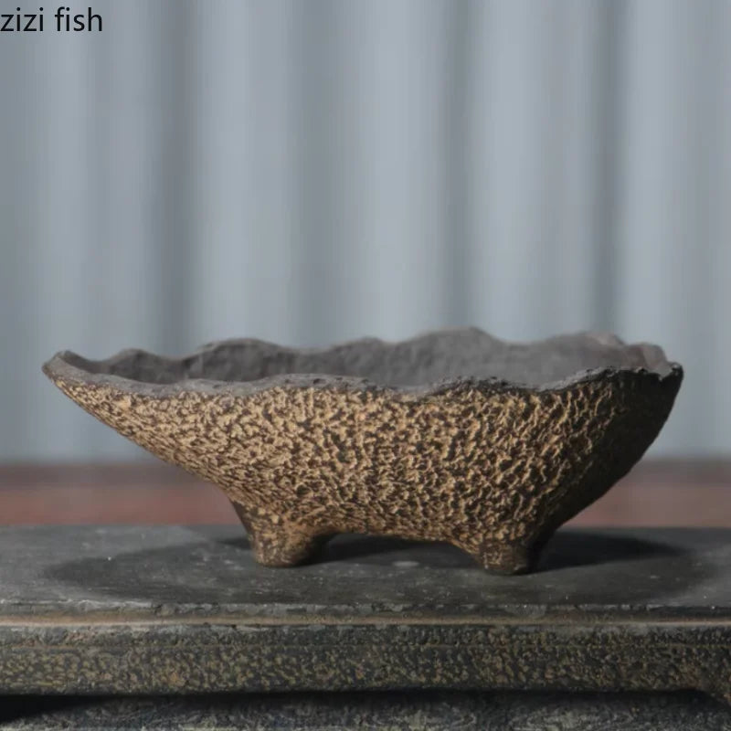 Speckled ceramic flowerpot planter with rough surface and dark interior rim