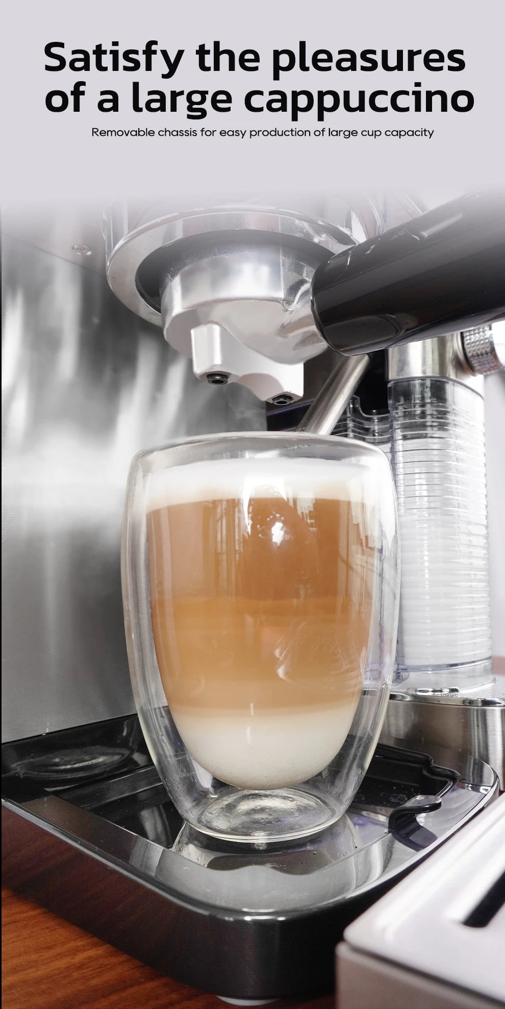 Stainless steel espresso machine filling a large glass of layered cappuccino with a removable chassis.