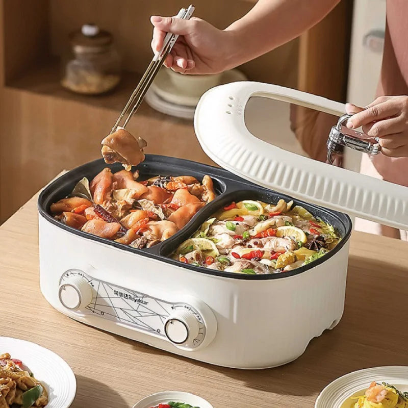 White double-compartment electric hot pot with lid open, cooking two dishes