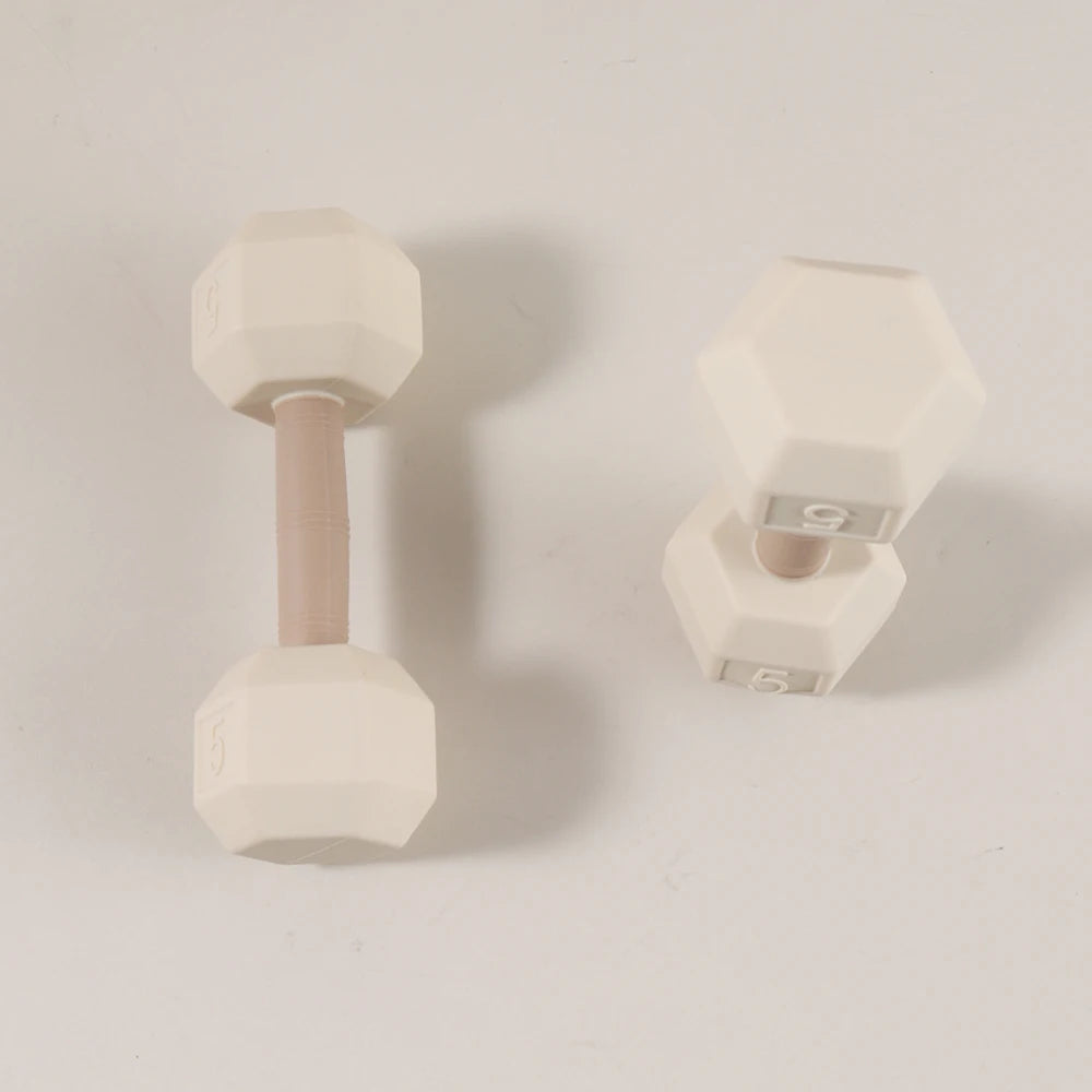 Beige silicone dumbbell baby teething toy for soothing sore gums.