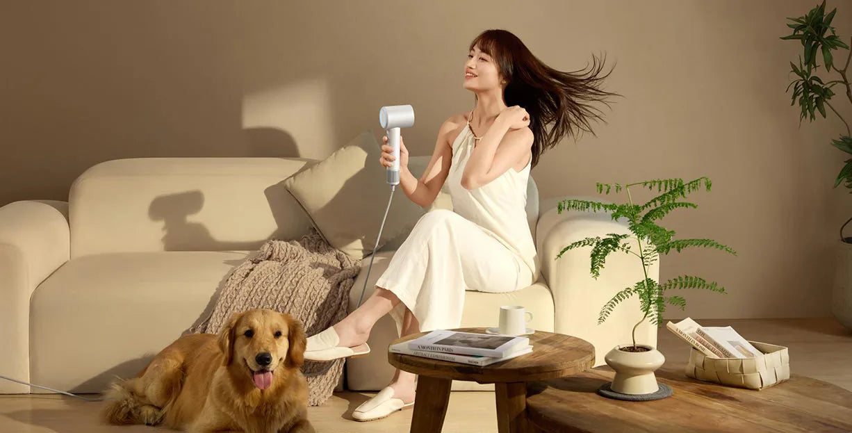 Woman using white Xiaomi Mijia H501SE high-speed hair dryer with powerful negative ion technology for fast hair drying.