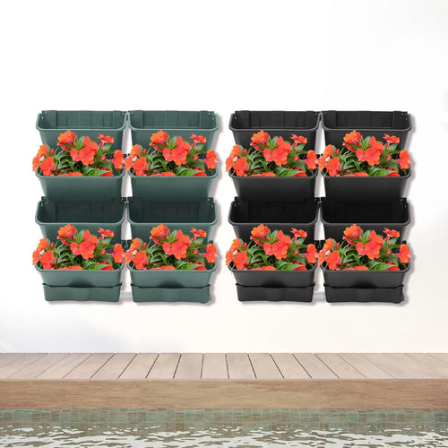 Wall-mounted vertical planter set with orange flowers in green and black planters