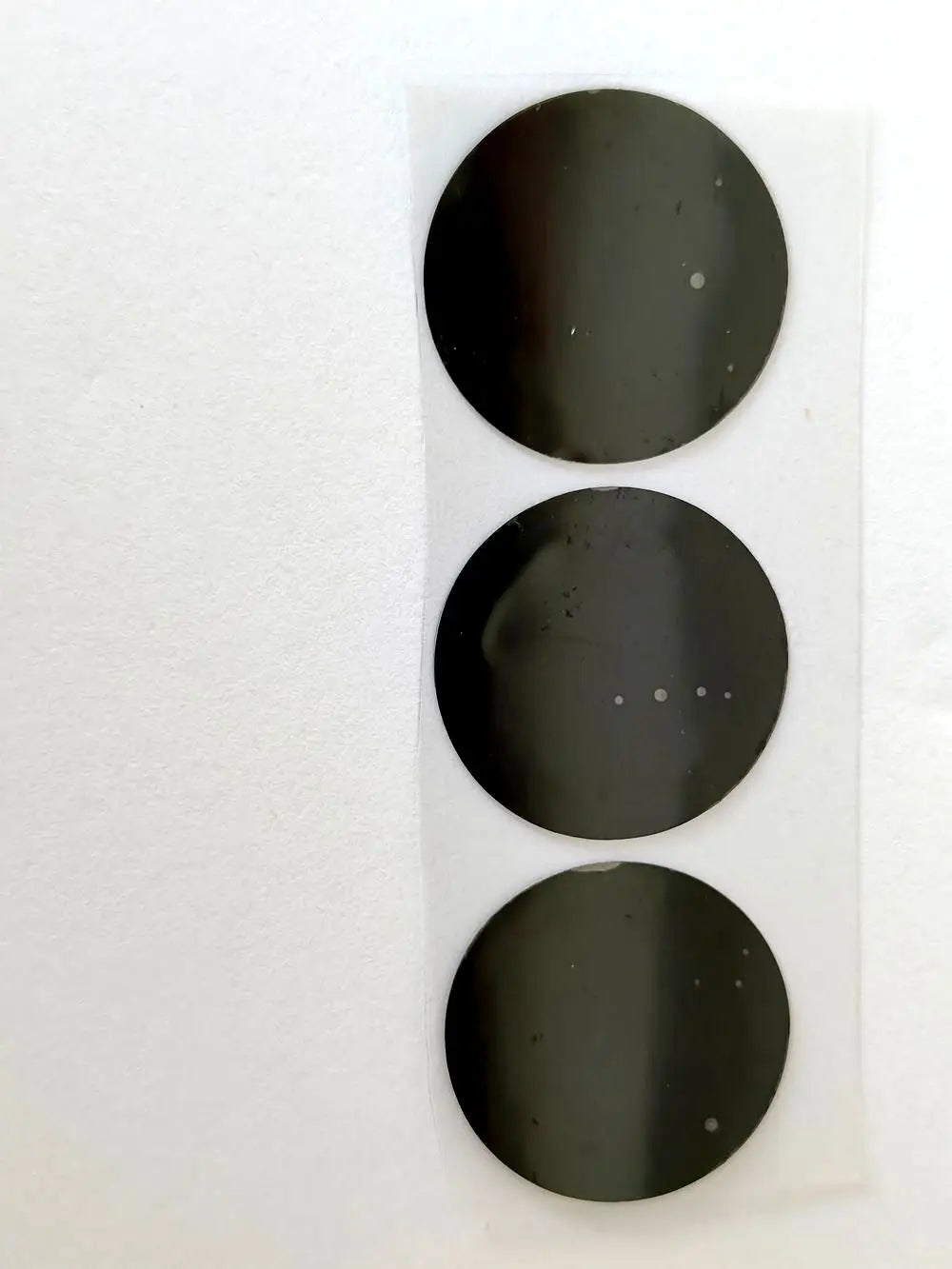 28mm black film replacement stickers for Vmax HIFU cartridges, three round adhesive labels on a clear backing strip.