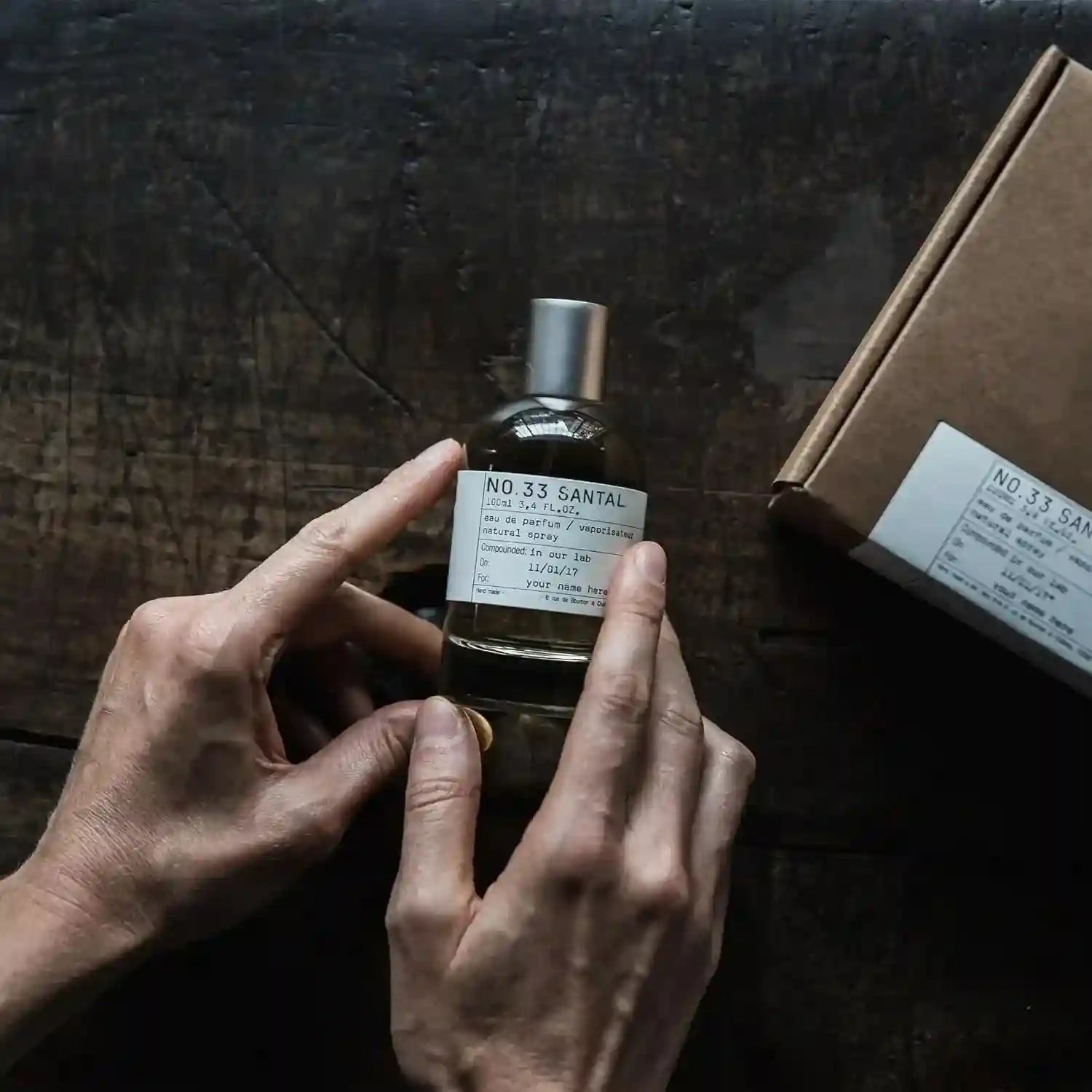 SantalX No.33 Santal unisex Eau de Parfum. Woody amber spicy scent in a sleek cylindrical glass bottle with label.