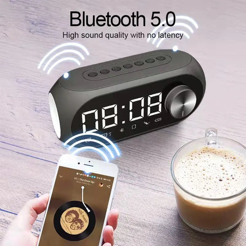 Black Bluetooth alarm clock speaker with glowing digital time display and volume knob