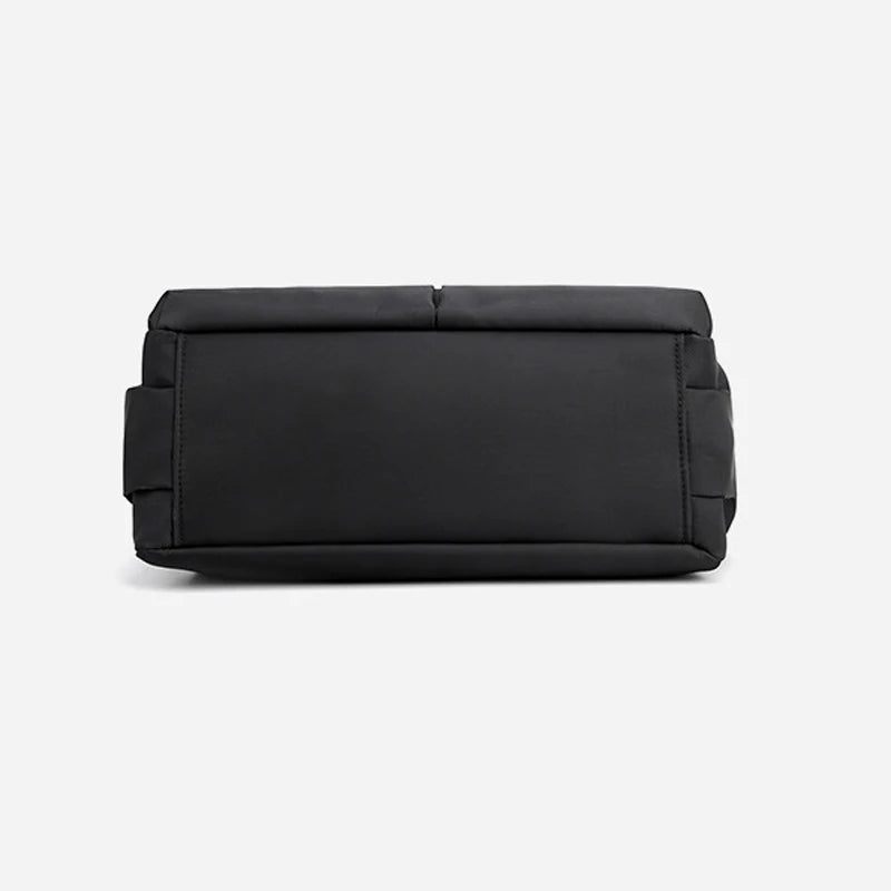 Minimalist black canvas designer handbag with a simple solid color, rectangular base, and durable casual style.