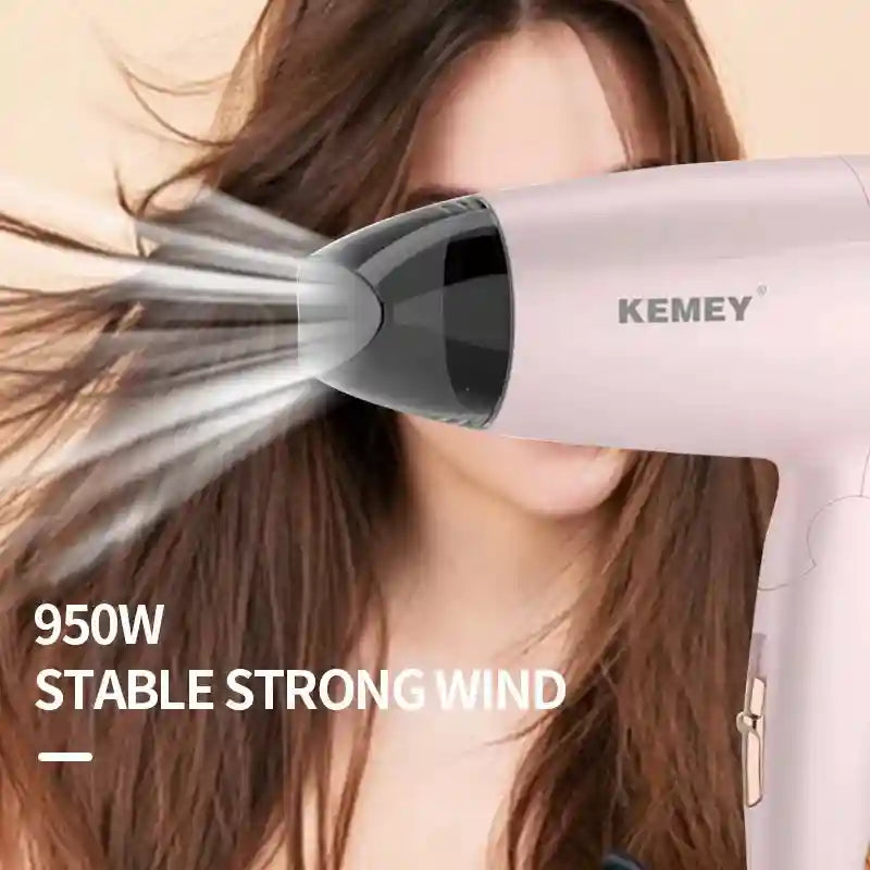 Pink Kemei 950W foldable travel hair dryer with concentrator nozzle for fast, stable drying. Compact student blower.