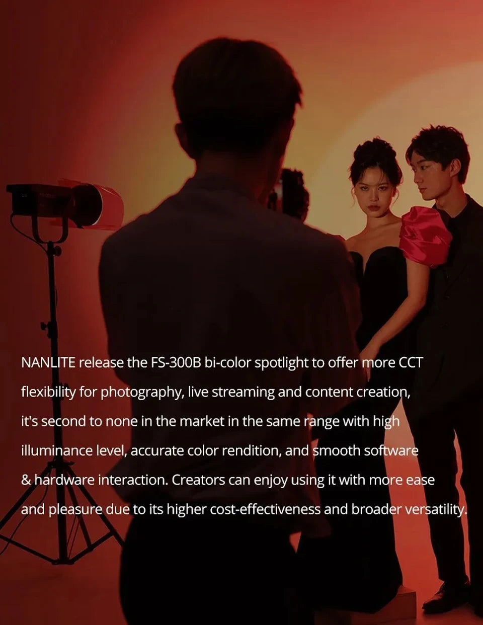 FS-300B bi-color spotlight on a black stand, lighting a photography studio setup with warm, red-toned ambient light.