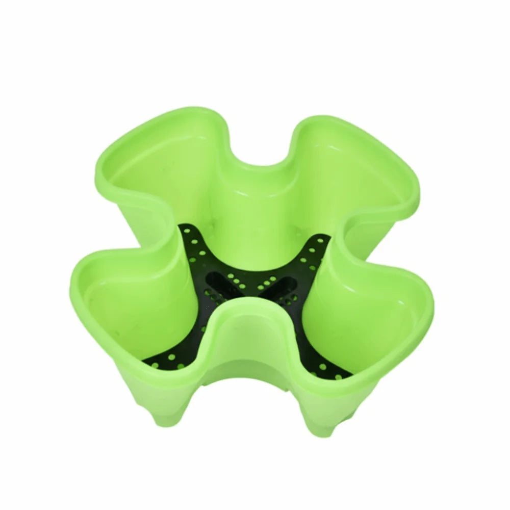 Green 4-petal plastic planter tray with central black drainage insert and molded petal cups