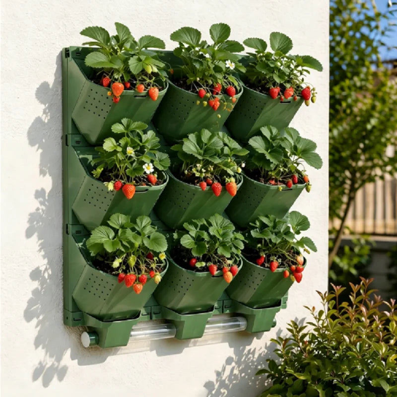 Green modular vertical garden planter with multiple planting cups and strawberry plants