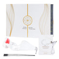 White red light therapy eye massager glasses with charging cable and manual for anti-wrinkle and eye fatigue relief.