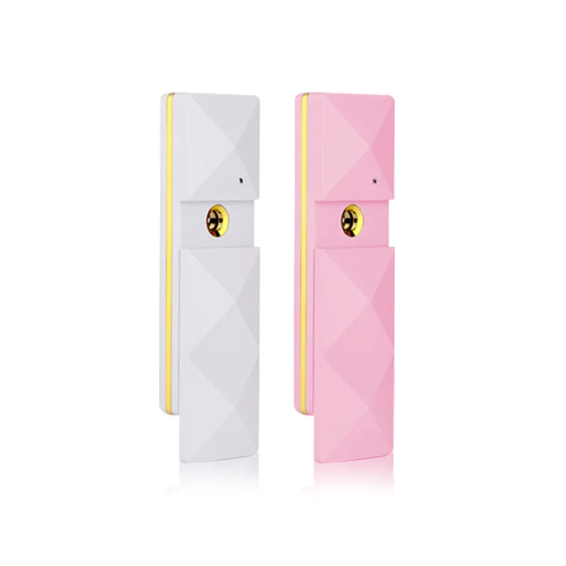 White and pink portable nano facial mist sprayers for skin hydration, pore cleaning, and eyelash extension care.