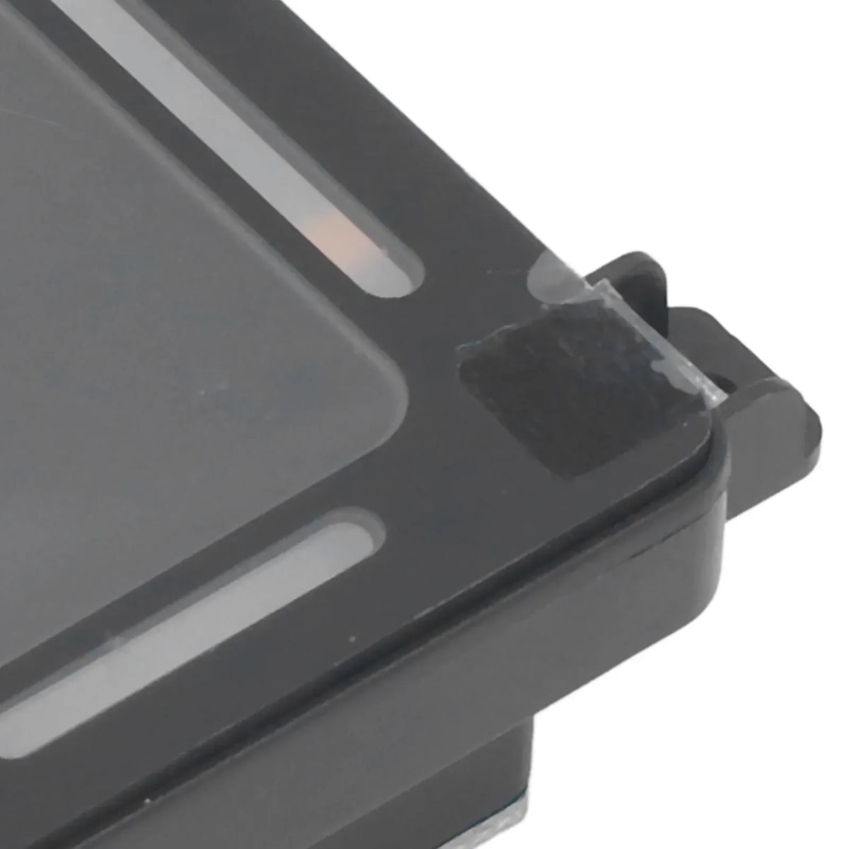 Close-up of black barcode reader module front housing and mounting edge