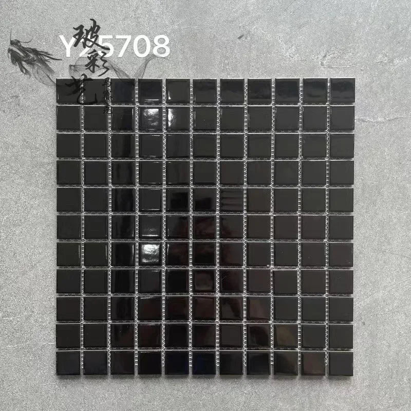 Ceramic mosaic tile sheet with small square dark gray tiles on grid backing