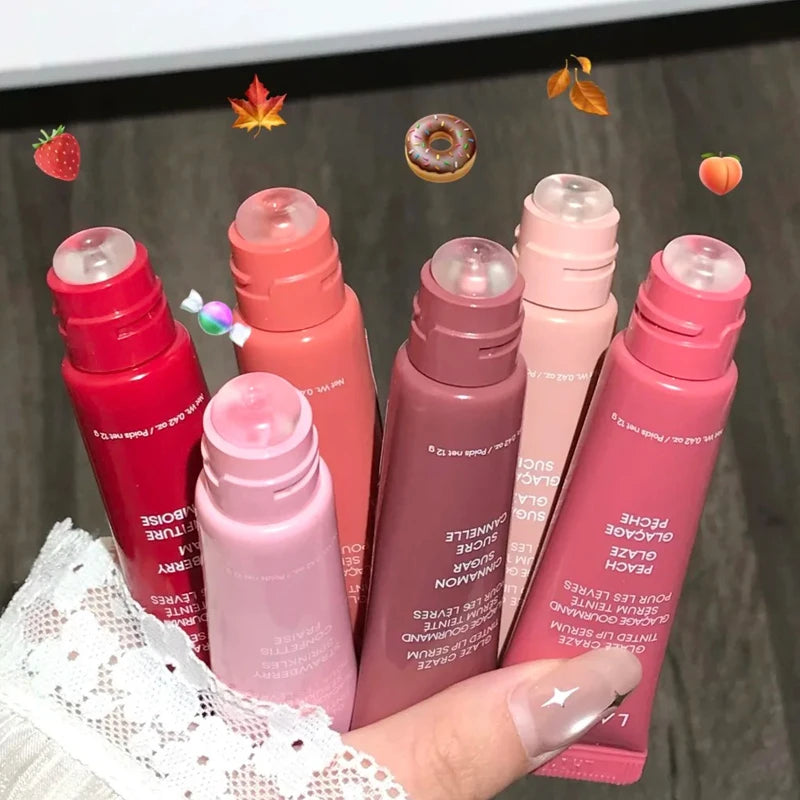 Laneige Glaze Tinted Polypeptide Serum Balms in various shades, held in a hand for moisturizing lip makeup care.