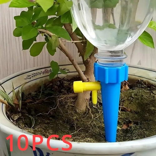 Blue drip irrigation watering stake with yellow connector, inserted into potted plant soil