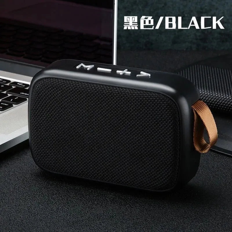Black Tidesmit rectangular portable speaker with fabric grille, metallic control buttons, and a tan carry strap.