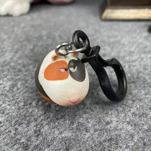 Cute guinea pig keychain character, tri-color resin ornament, ideal holiday gift or collectible pet bag charm.