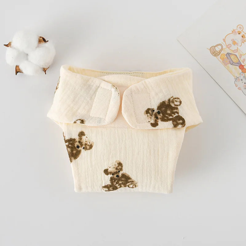 Soft cream-colored baby diaper with brown teddy bear print, made from comfortable fabric for baby care.