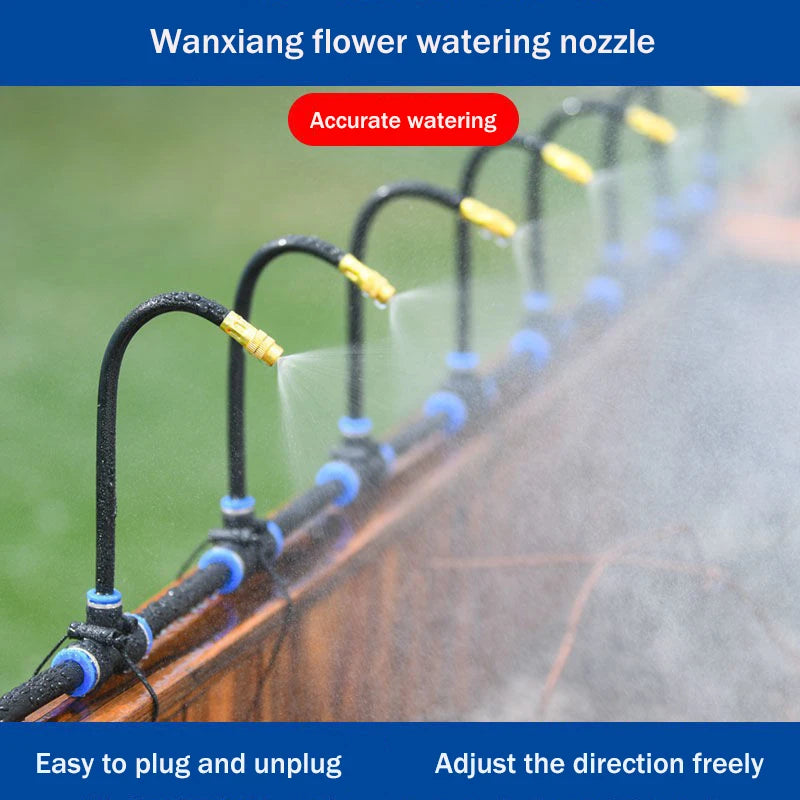 Rotating sprinkler nozzles with copper tips on a black manifold, misting water for plants