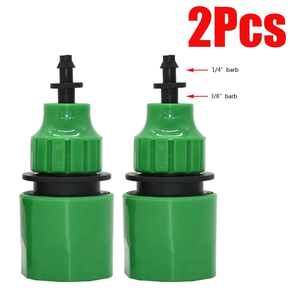 Green quick coupling adapters (2), black base, visible barbed connector tips
