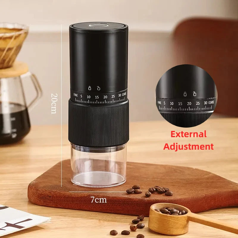Black manual coffee grinder with 20cm height, clear base, and external grind size adjustment dial on wooden table.