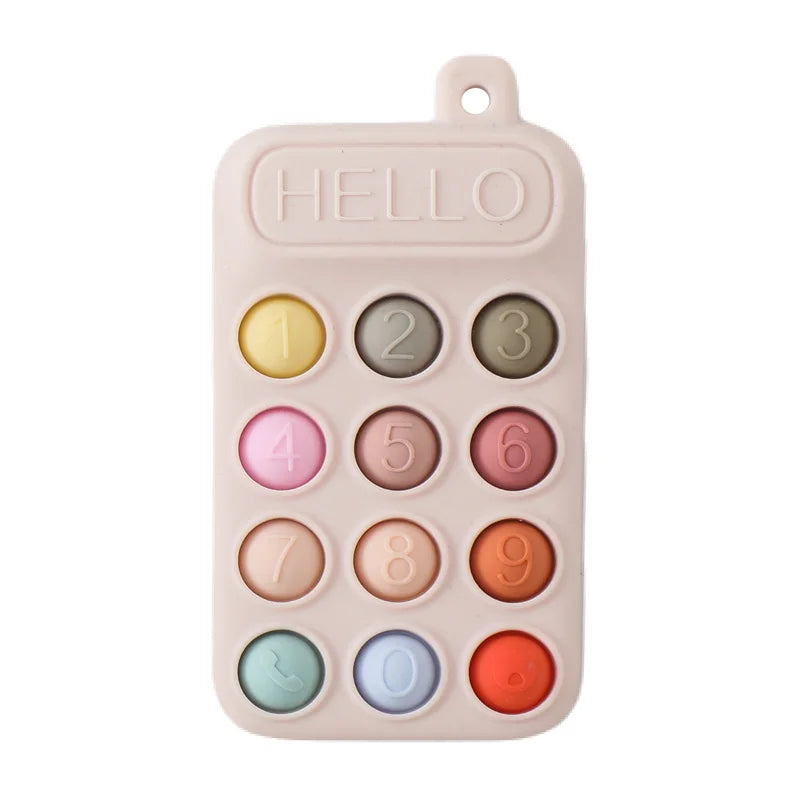 Beige silicone baby teething toy shaped like a phone with colorful number buttons for gum relief.