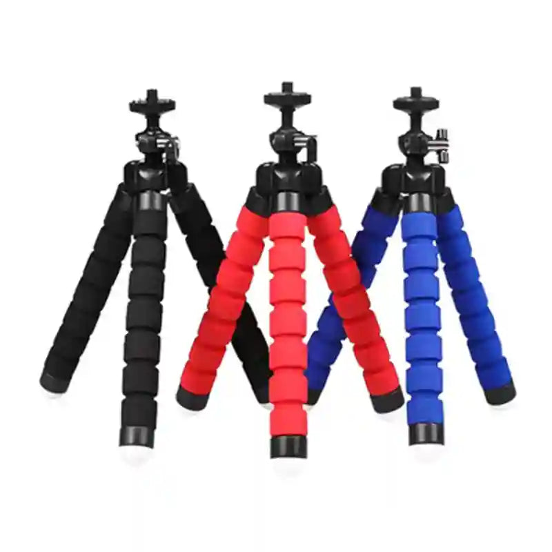 Flexible mini tripods with foam-covered legs in black, red, and blue for stabilizing phones or cameras.