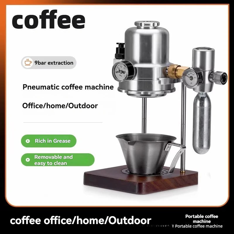Stainless steel pneumatic coffee maker with pressure gauges, wooden base, and cup for home or outdoor travel use.