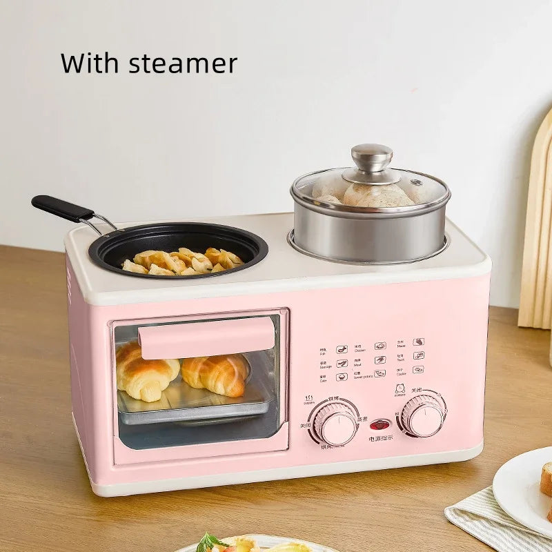 Mini 4-in-1 breakfast oven with pink base, glass door, black skillet and steamer pot.