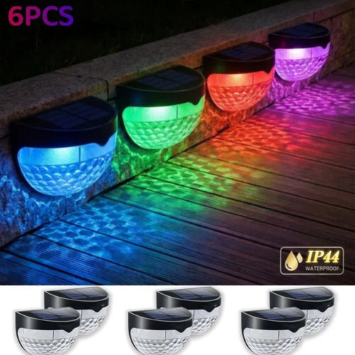 6-pack RGB solar fence lights with colored glow on a wooden deck, IP44 waterproof