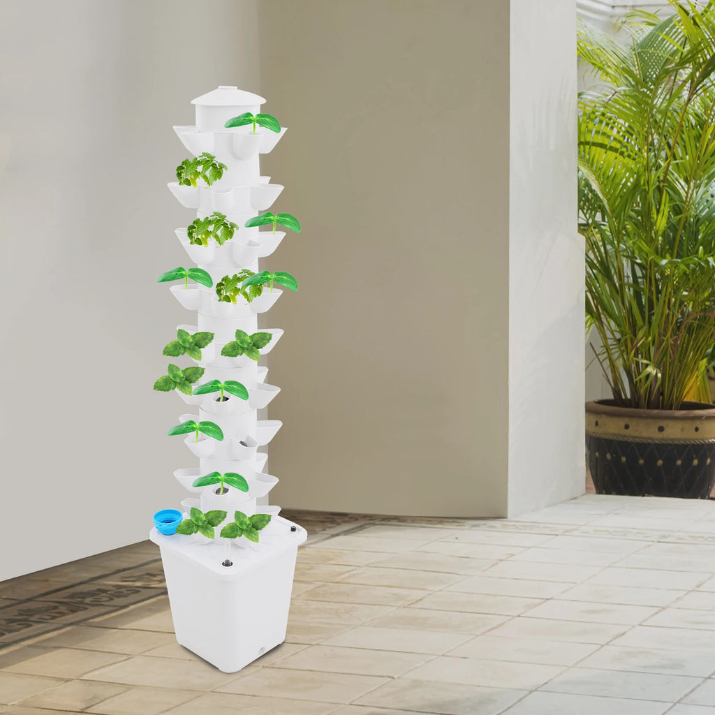White vertical hydroponic planter tower with leafy green plants in stacked holes