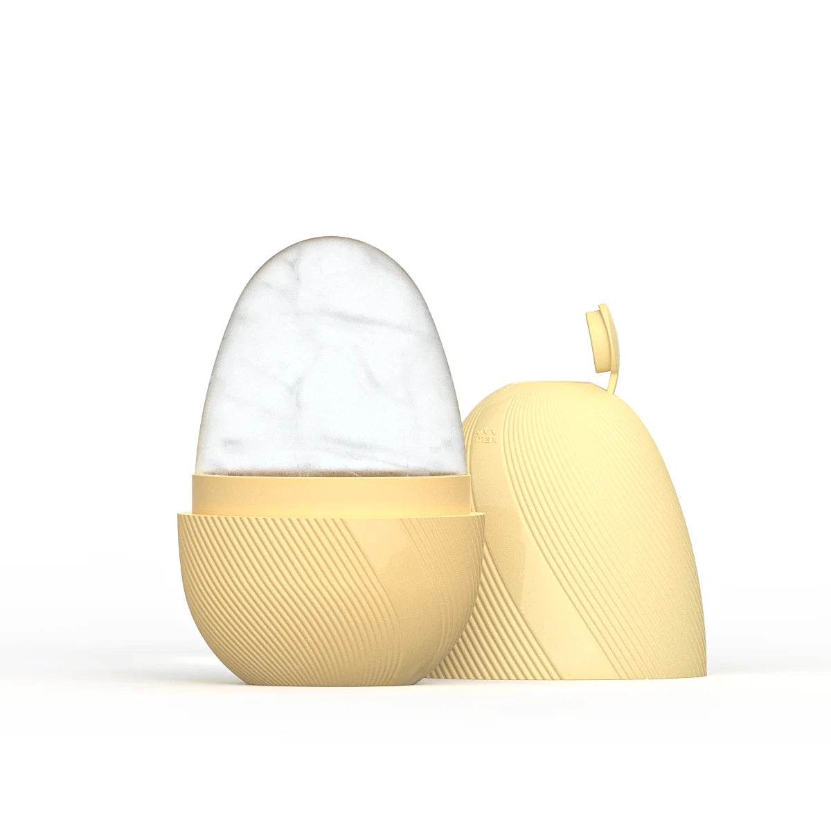 Egg-shaped yellow silicone ice face roller with a removable cap, revealing a frozen interior against a white background.