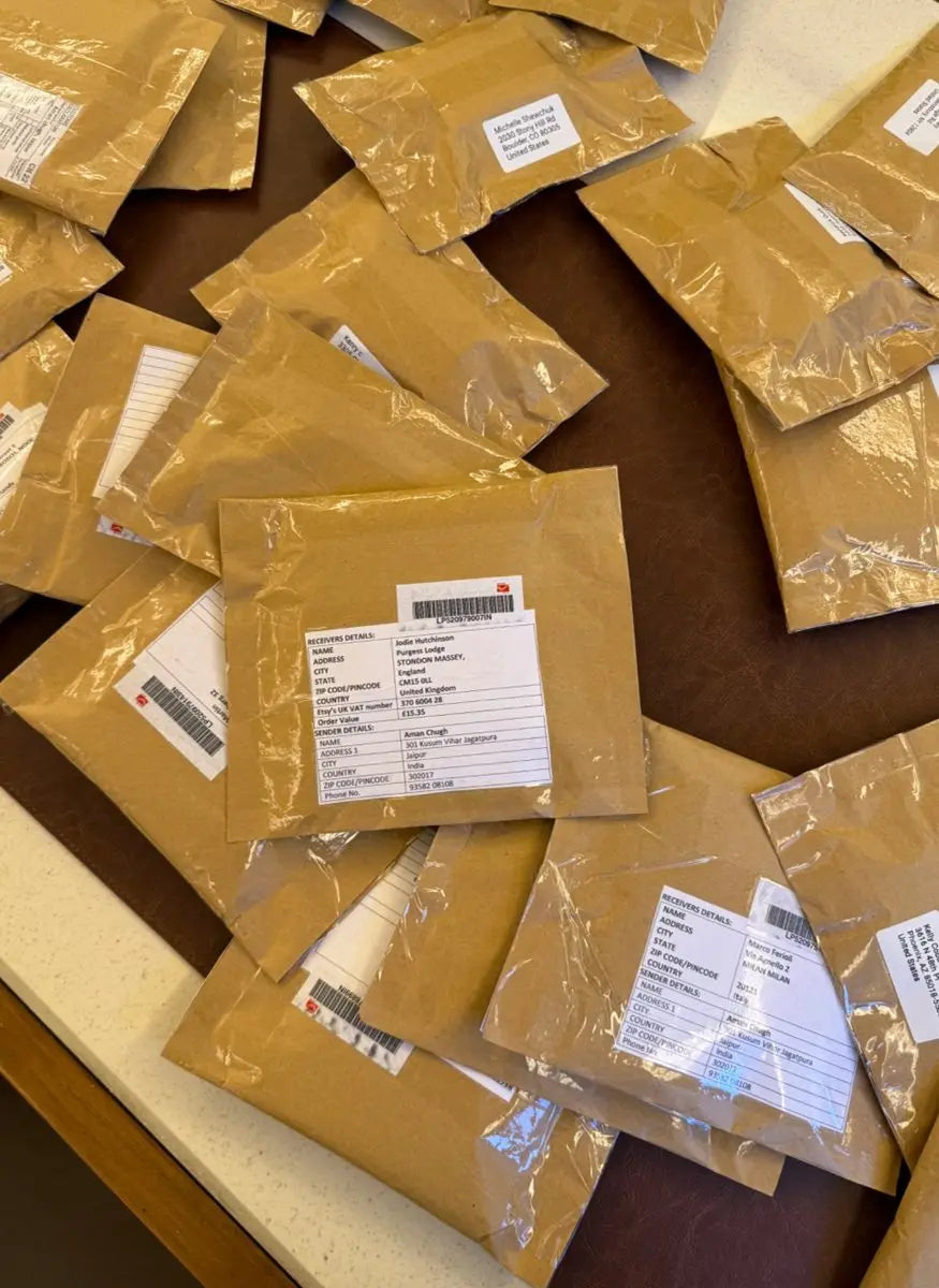Packaged jewelry supply parcels with label sheets in plastic bags