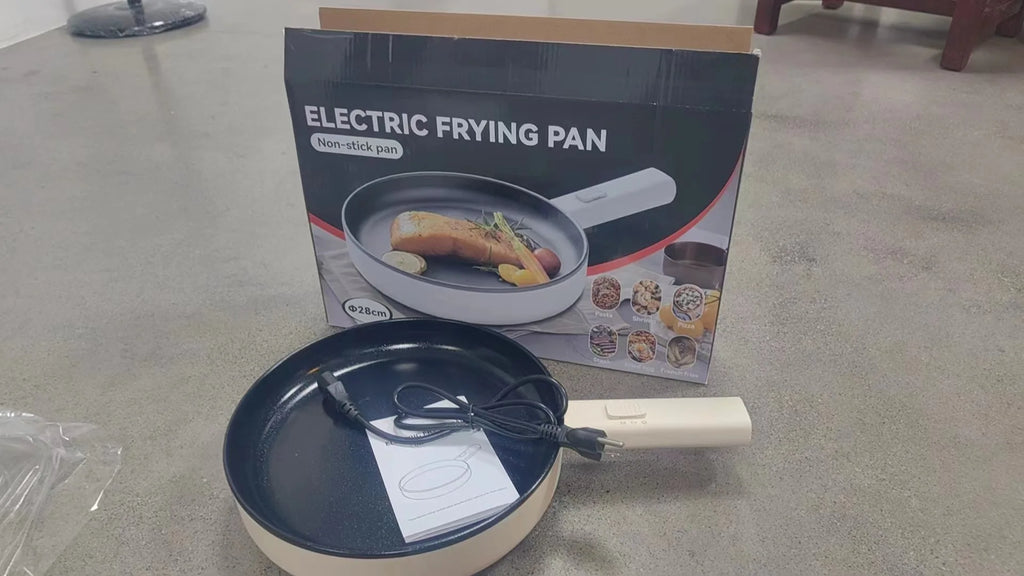 Electric frying pan with product box and power cord on countertop