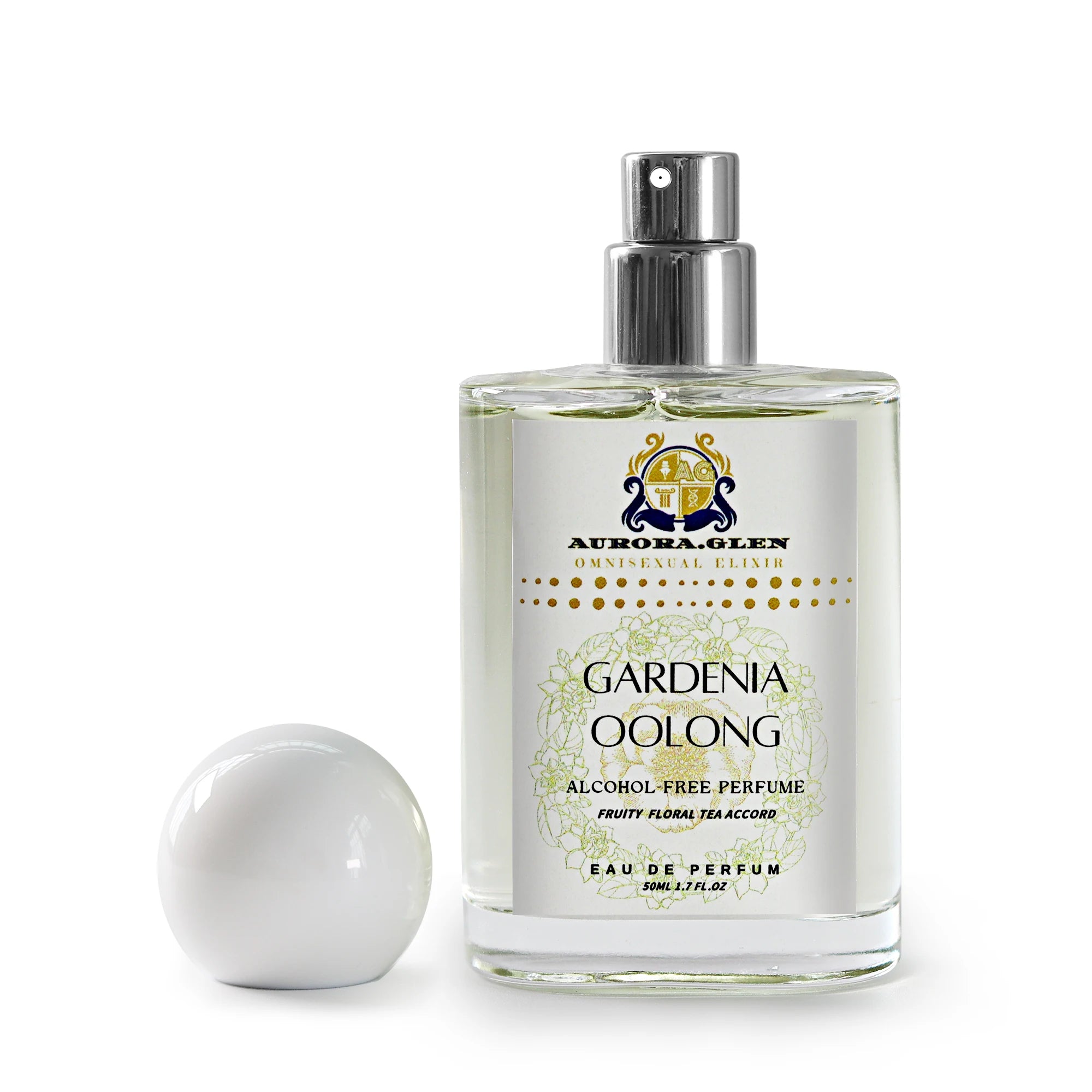 Clear glass bottle of Gardenia Oolong alcohol-free perfume with white spherical cap and floral label on white background.