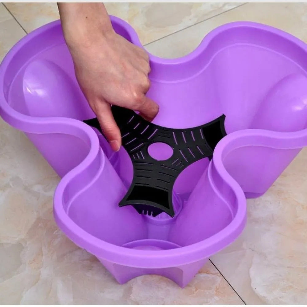 Purple 4-petal plastic planter insert with central black drainage base for vertical stacking