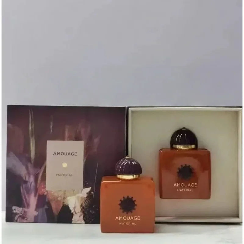 Amouage Material unisex EDP 100ml. Luxury woody oriental fragrance, square orange bottles with ornate domed caps.