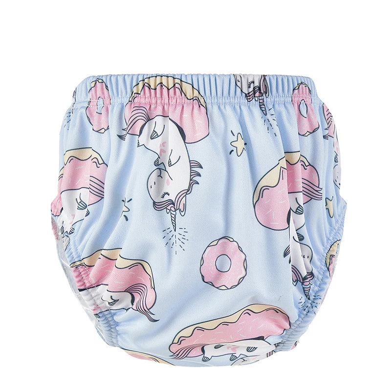 Reusable baby swim diaper in light blue with unicorn and donut print for baby care.