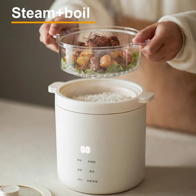 White rice cooker steaming pot with glass bowl held above open lid