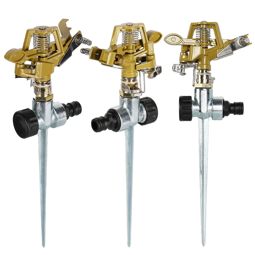 Set of three garden sprinklers with gold heads and silver stakes