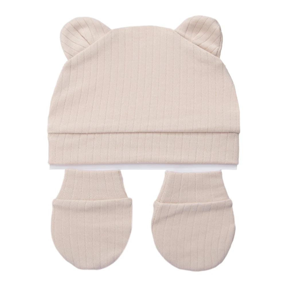 Beige ribbed cotton newborn set including a bear ear beanie and matching baby mittens.