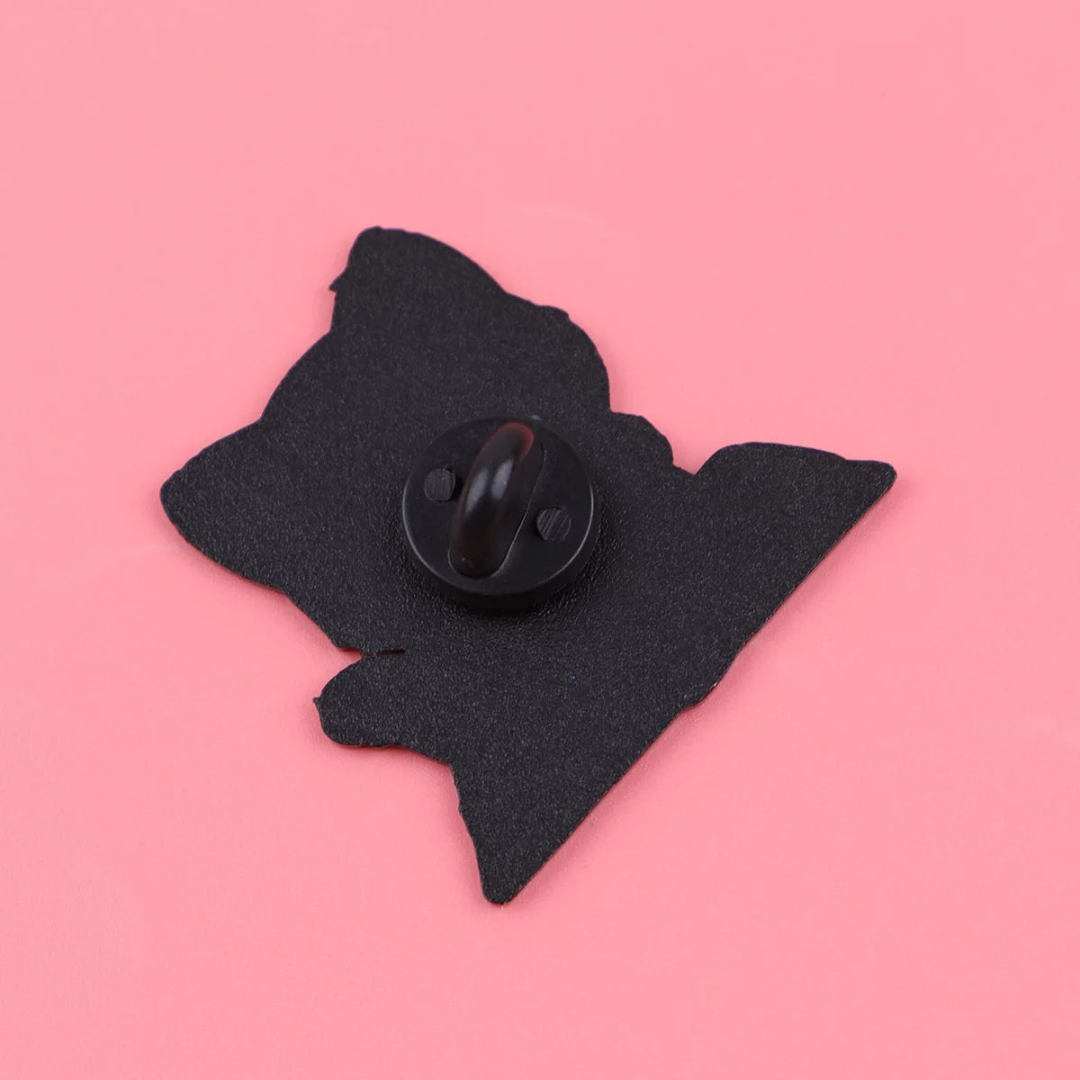Back of a black cat enamel pin brooch, showing the secure metal clasp for backpacks and clothing accessories.