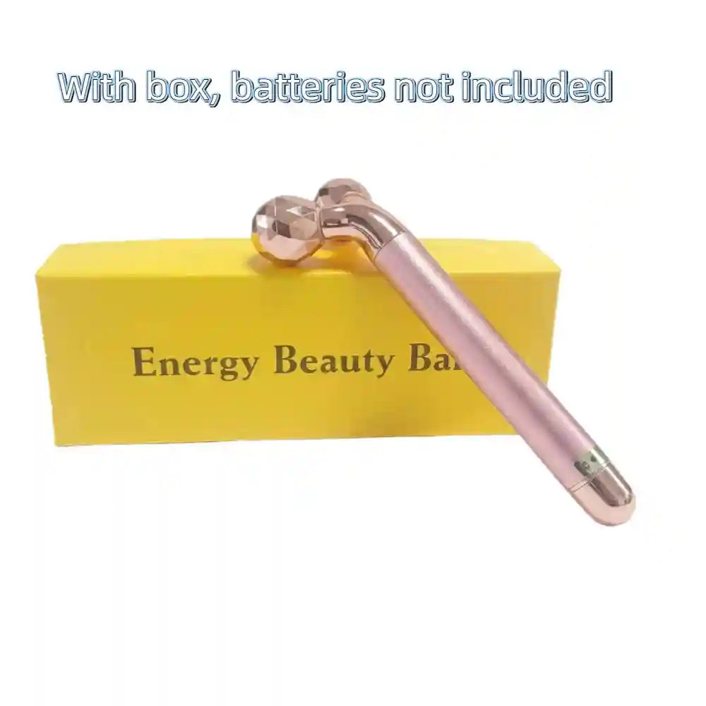 Rose gold facial massager with dual textured rollers, resting on a yellow "Energy Beauty Bar" product box.