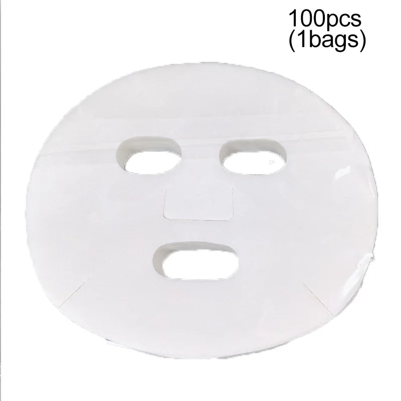 Thin, white, disposable facial mask sheet made of soft cotton with precut holes for eyes, nose, and mouth.