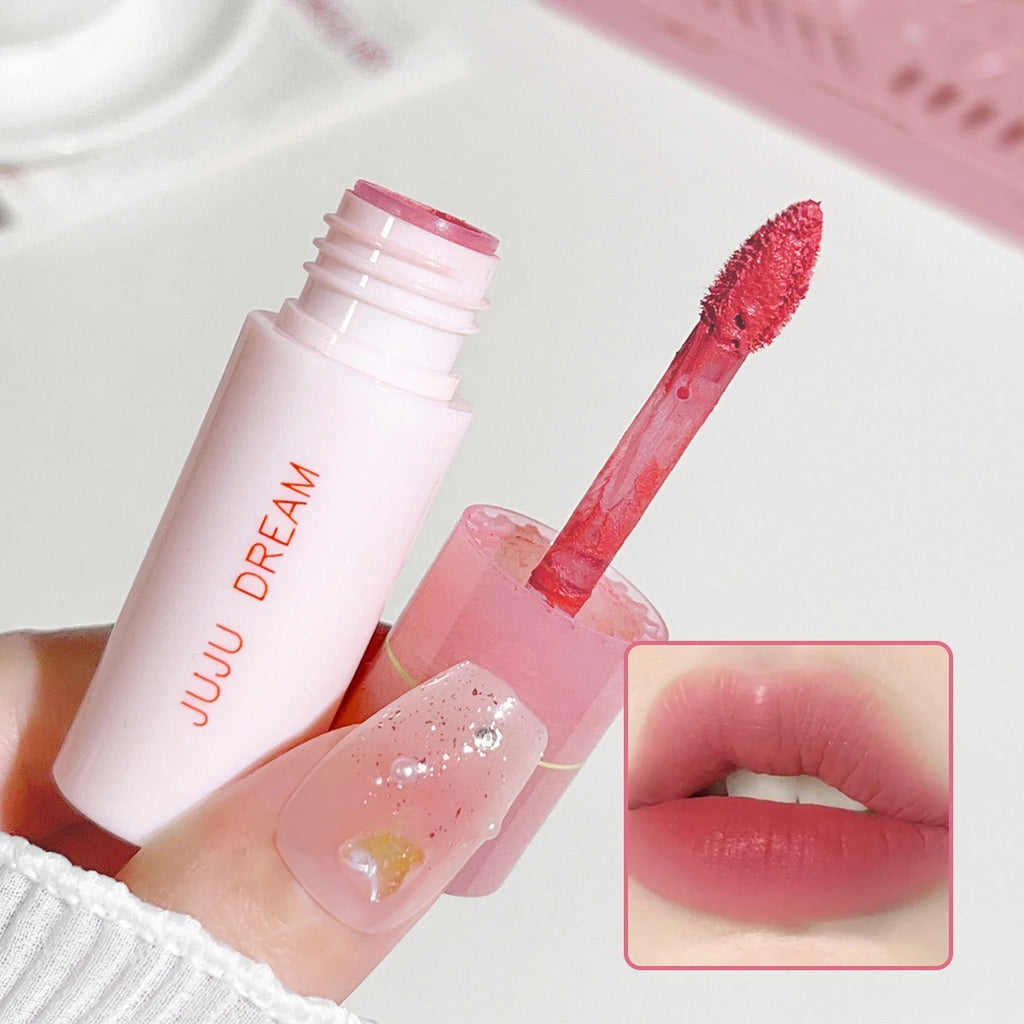 JUJU DREAM matte lip glaze in pink tube with velvet applicator and soft pink lip swatch. Non-stick long-lasting makeup.